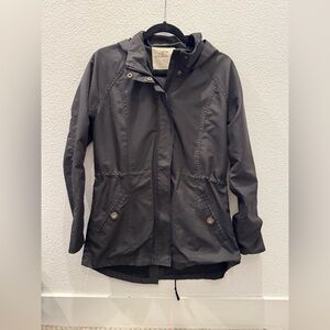 O'Neill women's black hooded raincoat with a cinched waist